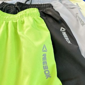 خرید اینترنتی شورتک ورزشی بغل گتر دار پارچه آیرو ریباک Reebok