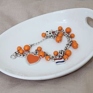 دستبند استیل نارنجی با آویز قلب توپ پرچم