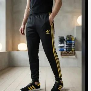 شلوار اسلش مردانه مدل آدیداس سه خط زرد رنگ مشکی جنس پارچه زهره درجه یک دمپا کش
